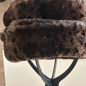 Faux fur leopard print hat.  Brown with black spots
